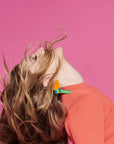 Profile of Drew Berrymore with her hair flying up in her face